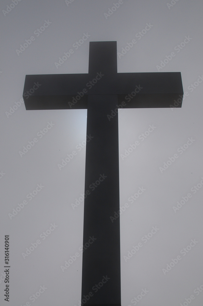 Religious cross in the fog