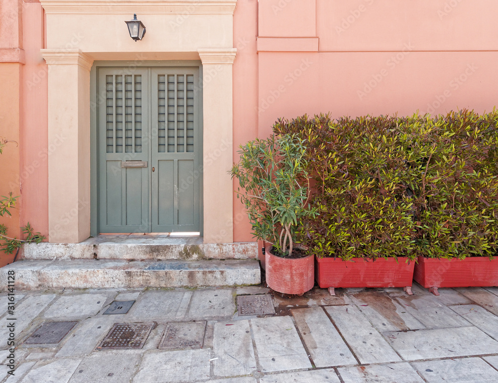 colorful house pale pink facade in old Plaka neighborhood, Athens Greece colorful house pale pink facade in old Plaka neighborhood, Athens Greece
