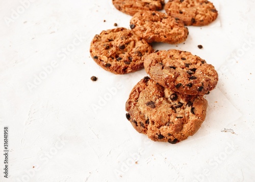 Oatmeal cookies with chocolate chips on a light background with space for text.