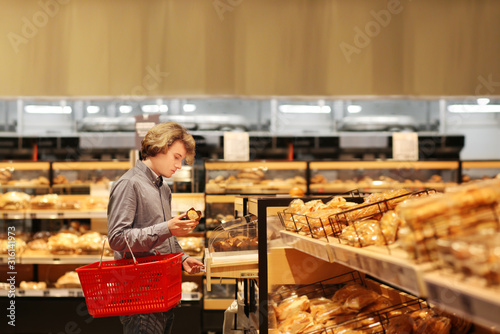 Teenager choosing bread from a supermarket 