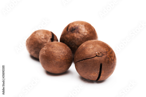 Shelled macadamia nuts on white background
