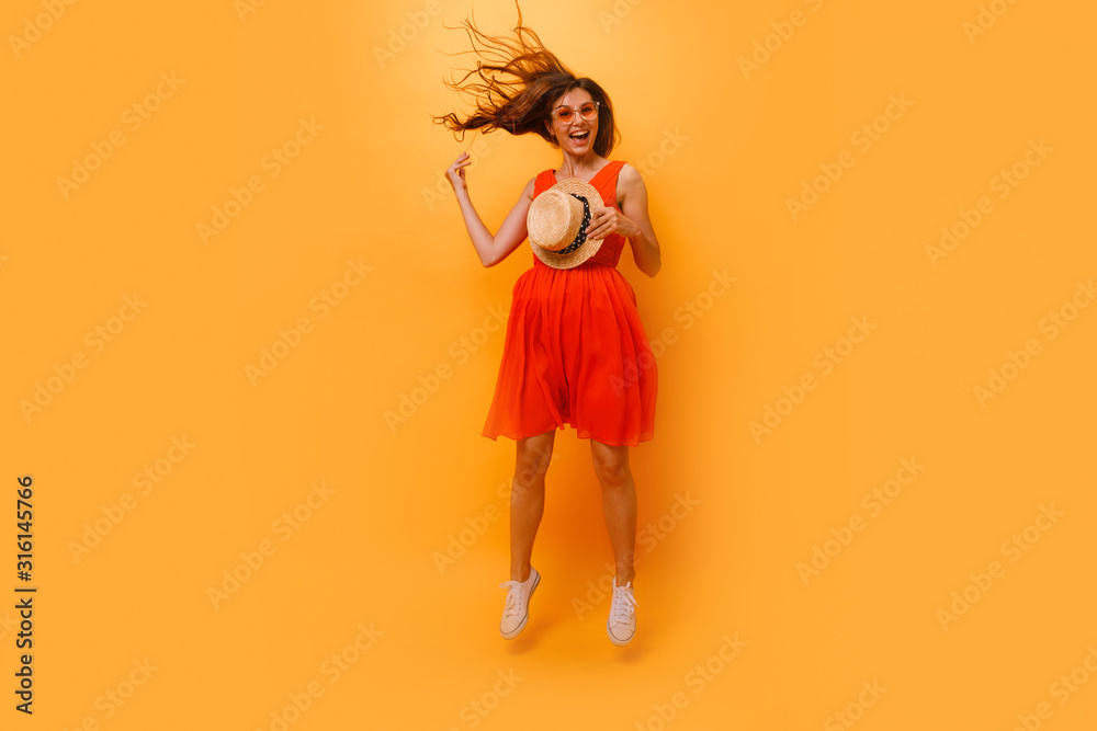 Close up shot of stylish young woman in sunglasses smiling against yellow background. Beautiful female model with copy space.Energized lovely happy good-looking joyful girl curly. Copy space Close up shot of stylish young woman in sunglasses smiling against yellow background. Beautiful female model with copy space.Energized lovely happy good-looking joyful girl curly. Copy space