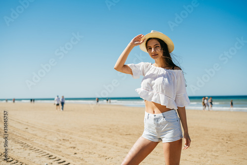 girl on a wide sandy beach poses for a photographer © mnelen.com