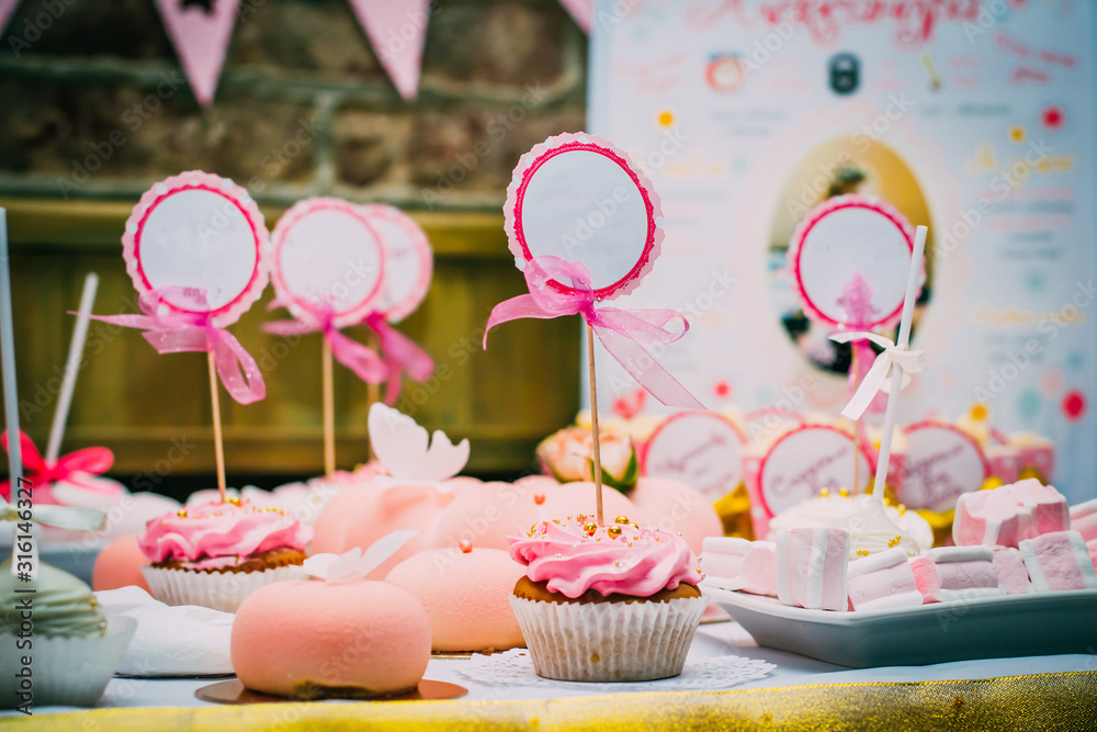 Raspberry cupcake with a sign for inscription with a bow Raspberry cupcake with a sign for inscription with a bow