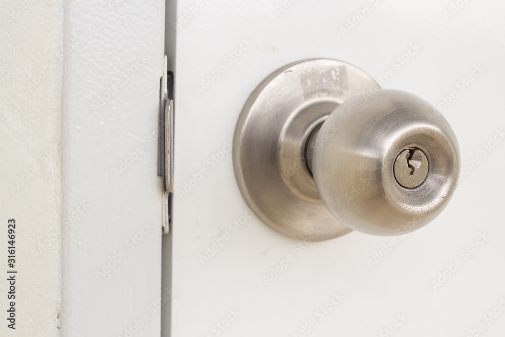 Aluminum door knob on the white door skin. Aluminum door knob on the white door skin.