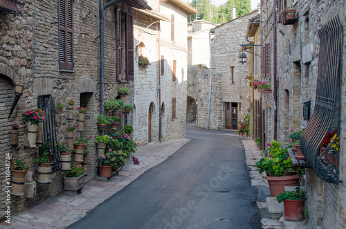 A medieval picturesque street in Assisi, Italy. © katspi