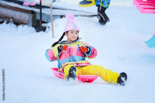 Asian girls playing snow happily in japan. , Children playing in the snow , Children playing in the snow happily.Asian boy playing snow happily in japan.
