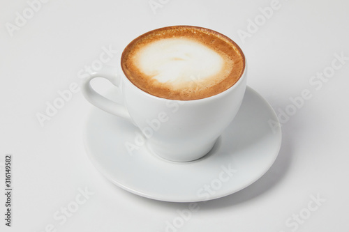 A cup of Cappuccino Latte coffee without a spoon on a white background. Ready for menu  studio shot