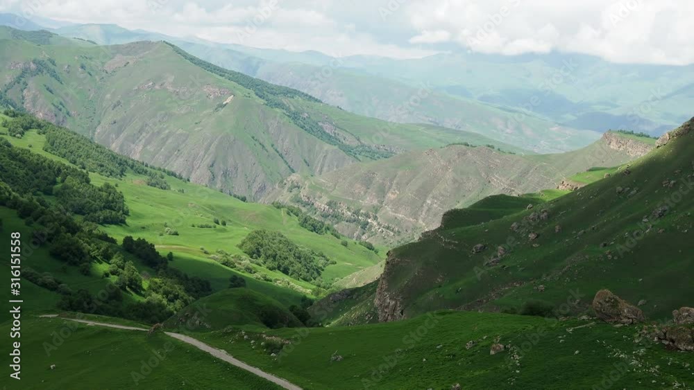 beautiful mountain landscape with views of the pass and the mountains covered with green bright grass on a Sunny summer day beautiful mountain landscape with views of the pass and the mountains covered with green bright grass on a Sunny summer day