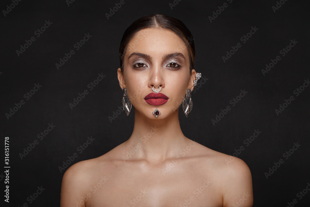 Beautiful makeup. Caucasian girl model with perfect makeup and suntanned skin, big eyes and lips, eyebrows, jewelry in ears, nose and chin. Beautiful makeup. Caucasian girl model with perfect makeup and suntanned skin, big eyes and lips, eyebrows, jewelry in ears, nose and chin.