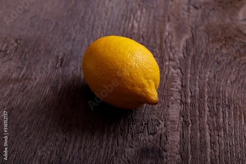 Fresh lemon on old rustic vintage wooden table. Top view with place for text.