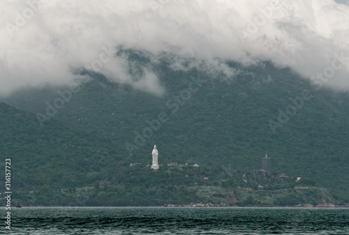 Scenic view of clouds rolling over the mountain and Linh Ung pagoda on Son Tra Peninsula. Da Nang in Central Vietnam photo