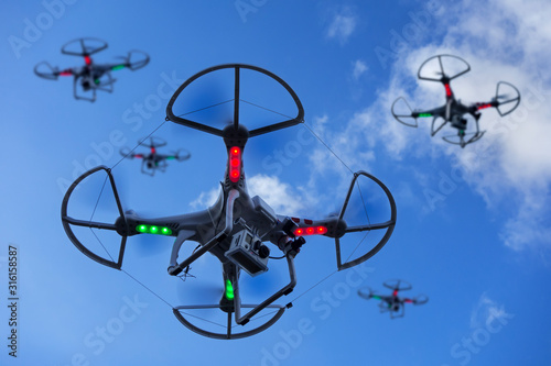 Miniature drones equipped with camera in flight photo