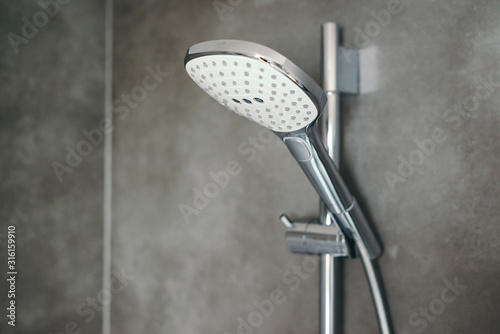 Shower head on grey modern wall. Bathroom shower. New head shower in a modern bathroom