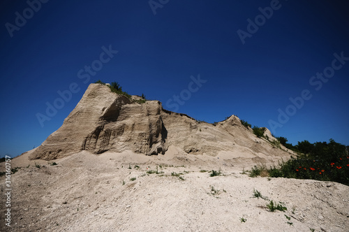 Mountain of white sand. A white mountain of white stones.Sandy hill above the abandoned quarry.