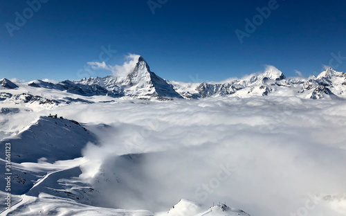 panorama view Zermatt Matterhorn gornergrat emerging from sea of clouds fog perfect sky