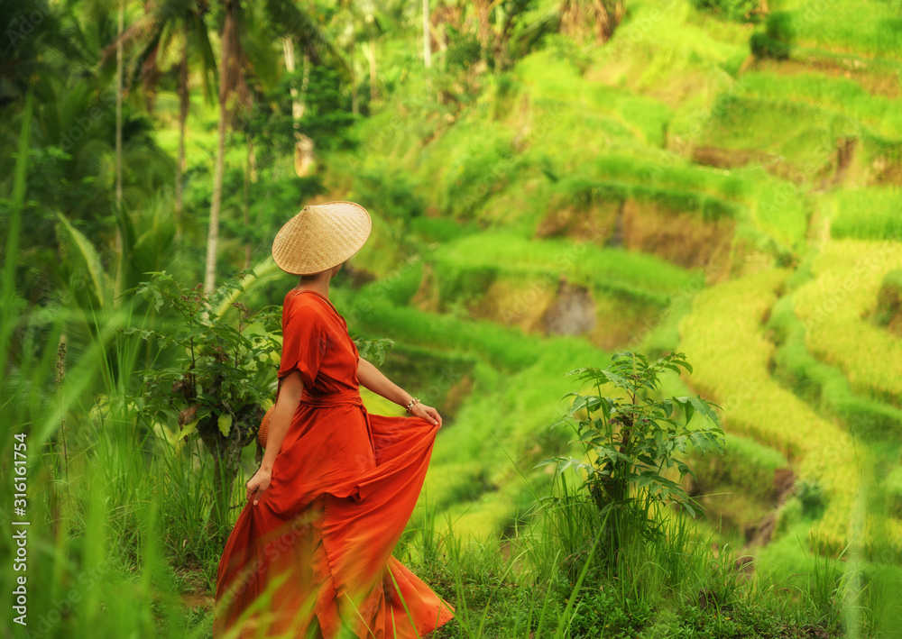 Woman walking on Tegalalang Rice Terrace, Bali Woman walking on Tegalalang Rice Terrace, Bali