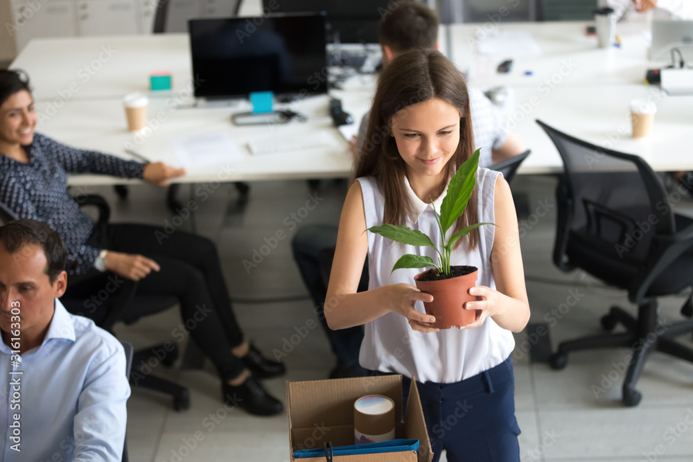 Excited employee settle at new workplace on first work day Excited employee settle at new workplace on first work day