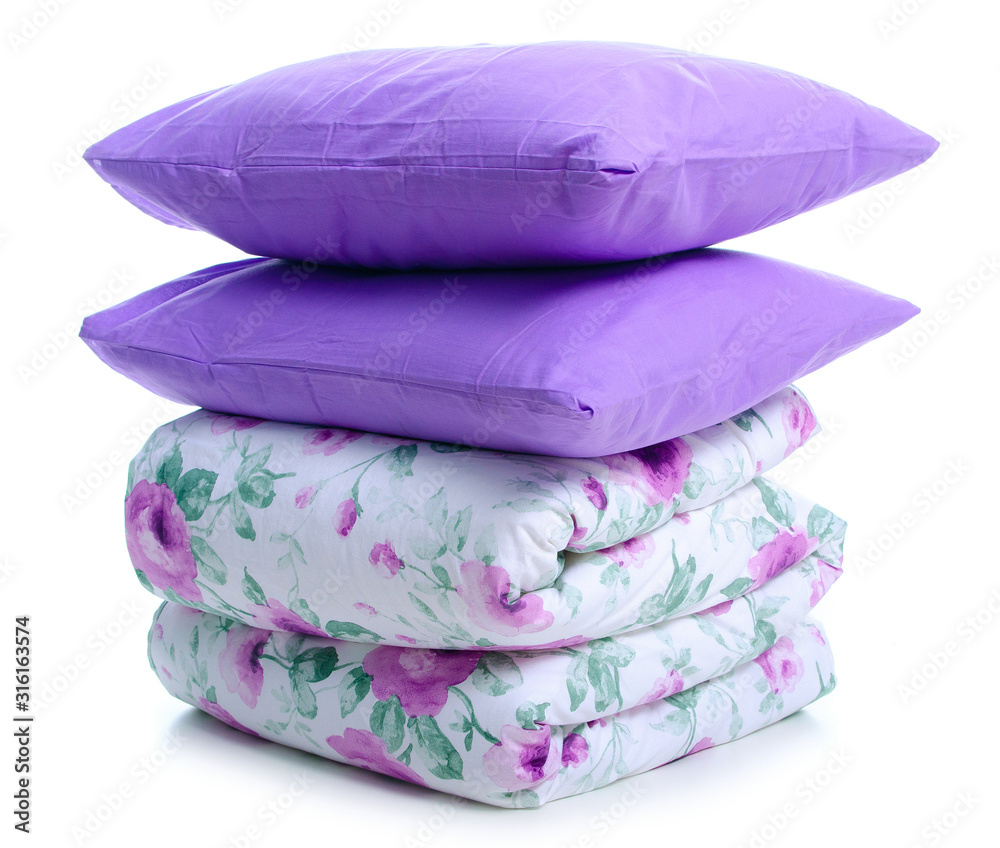 Folded soft warm blanket with pillows on white background isolation Folded soft warm blanket with pillows on white background isolation