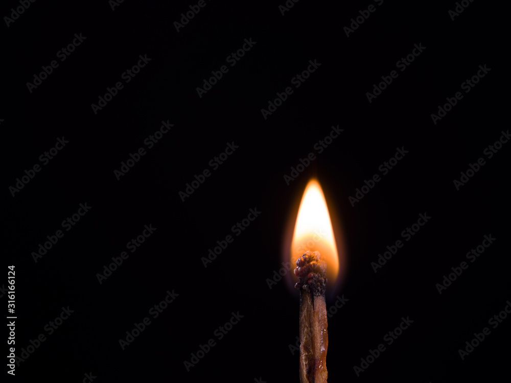 Burning match on black background. Empty with copy space for advert text. Side view Burning match on black background. Empty with copy space for advert text. Side view