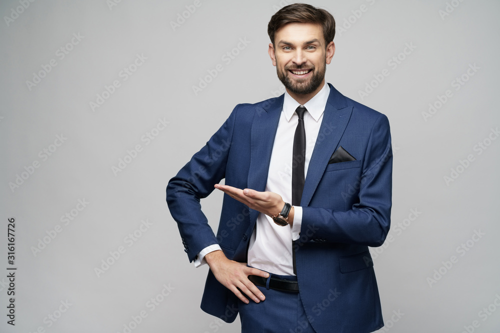 Portrait of a young businessman pointing on a copyspace with his finger - obrazy, fototapety, plakaty 