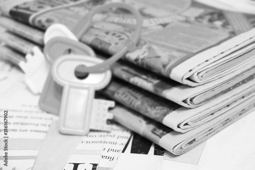 Stack of Newspapers and Bunch of Keys. News Pages with Headlines and Toy Keys, Business Concept Stack of Newspapers and Bunch of Keys. News Pages with Headlines and Toy Keys, Business Concept