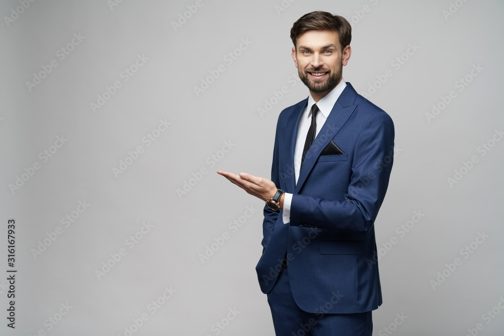 Portrait of a young businessman pointing on a copyspace with his finger - obrazy, fototapety, plakaty 