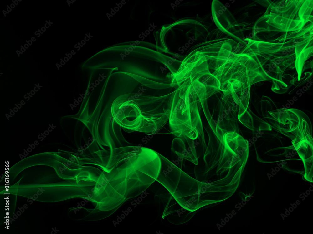 Green smoke abstract on black backgroud for design, darkness concept Green smoke abstract on black backgroud for design, darkness concept