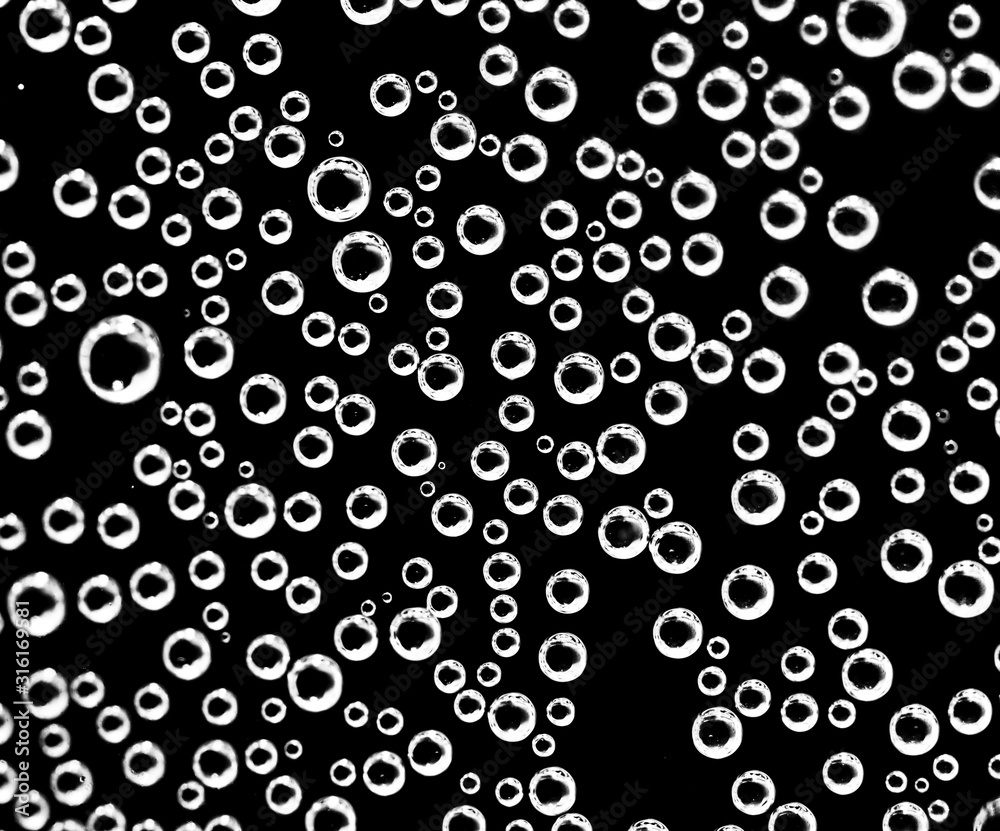 Air balls in water on a black background