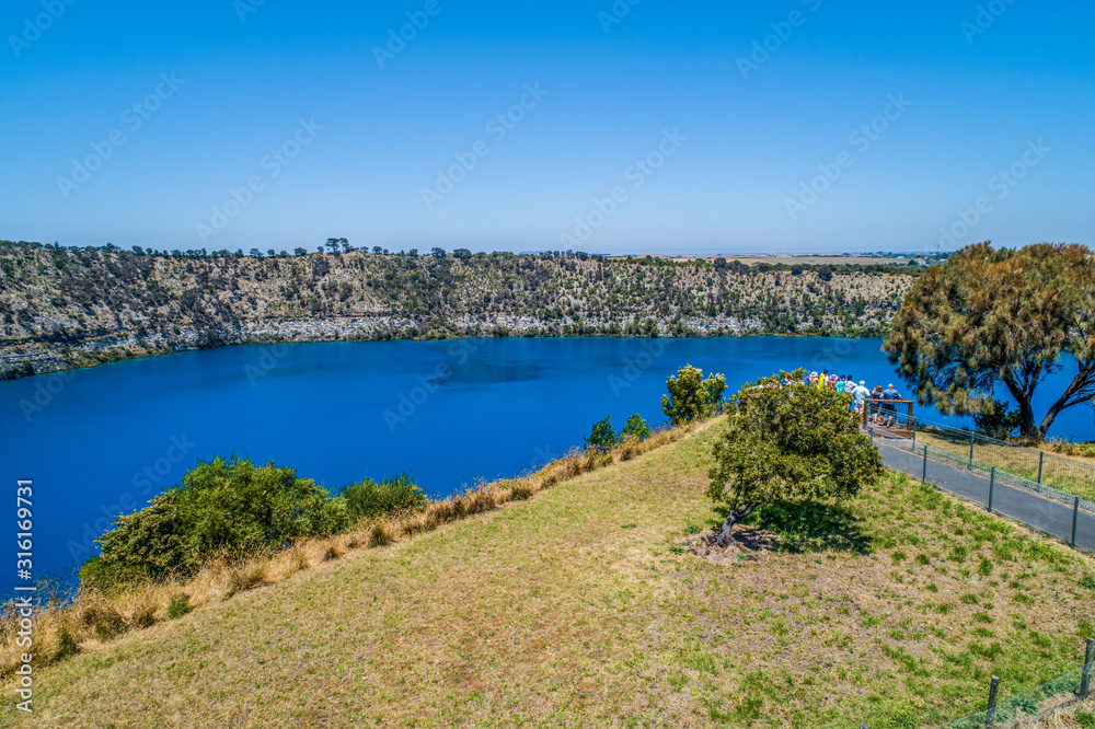 Fototapeta premium Aerial view of tourists admiring the Blue Lake in Mount Gambier, South Australia