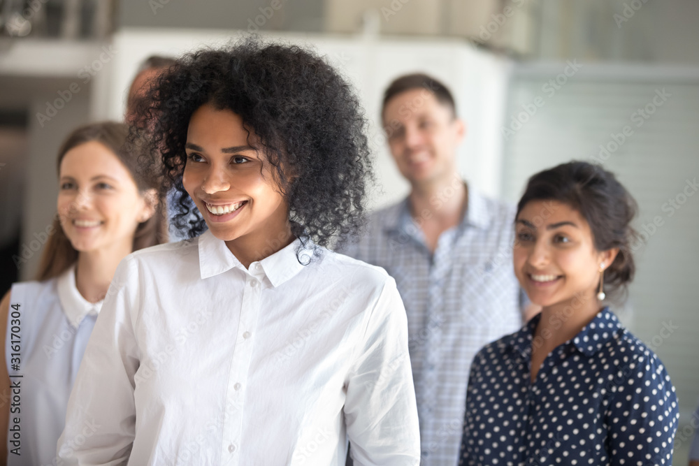 Excited multiracial team posing for group picture in office Excited multiracial team posing for group picture in office