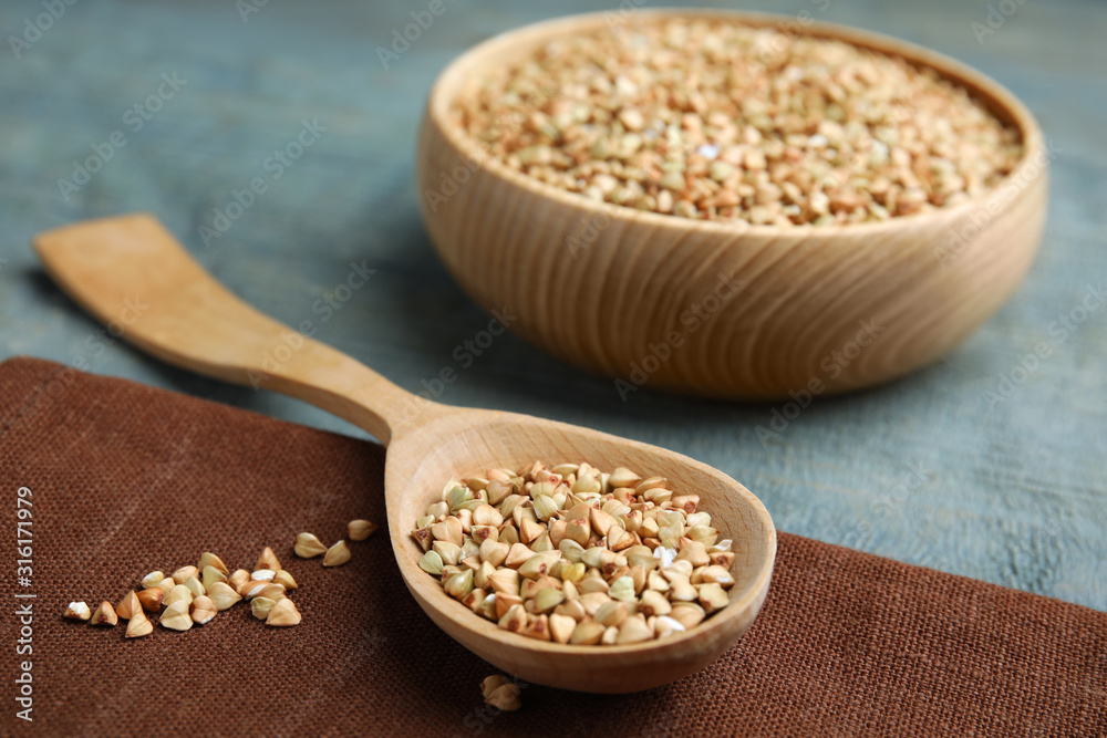 Uncooked green buckwheat grains on table, closeup Uncooked green buckwheat grains on table, closeup