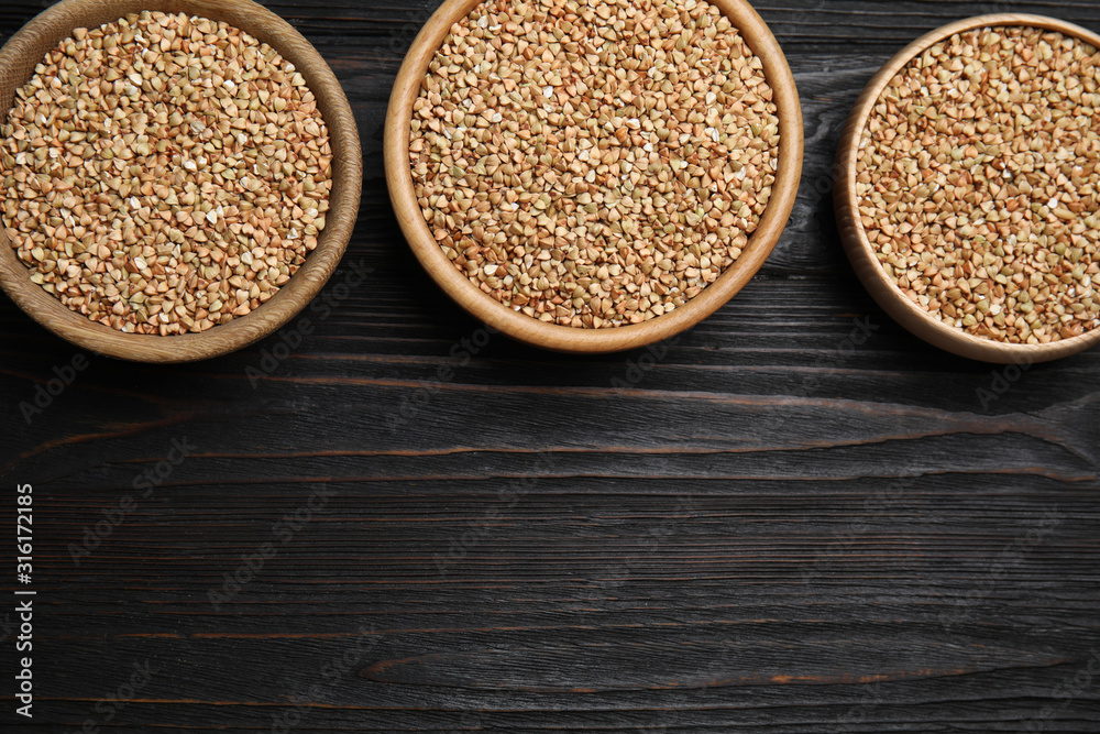 Flat lay composition with green buckwheat on black wooden table. Space for text Flat lay composition with green buckwheat on black wooden table. Space for text