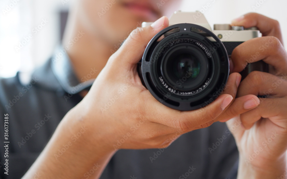 Man photographer holding black camera and taking photo. Man photographer holding black camera and taking photo.
