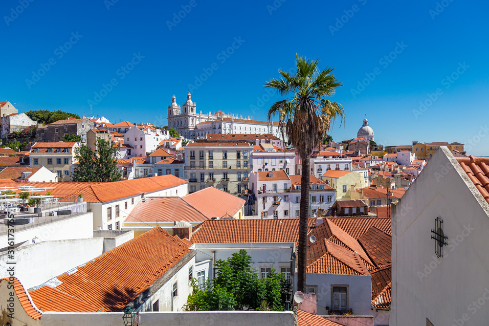 Skyline of Lisbon and the old Alfama district on a summer day with a bright blue sky