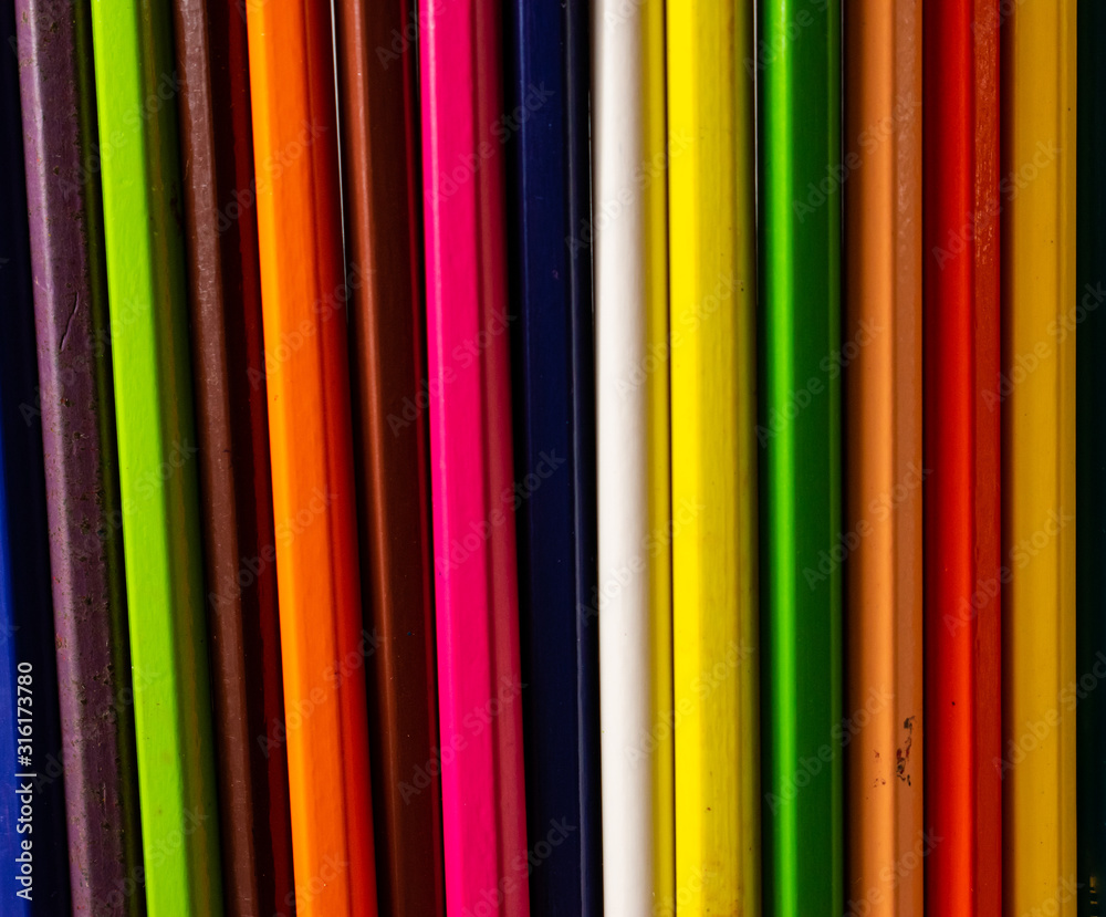 Different colors of pencils, in a straight line pattern. Colored crayons arranged in a meaningful way. Different colors of pencils, in a straight line pattern. Colored crayons arranged in a meaningful way.