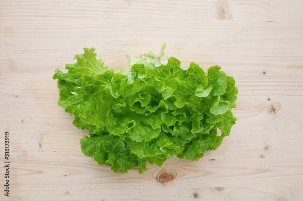 Lettuce on a wooden background. Lettuce on a wooden background.