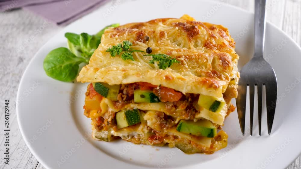 vegetable lasagne with cream and cheese- slow motion vegetable lasagne with cream and cheese- slow motion