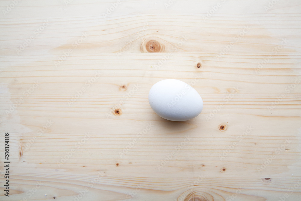 One egs on a wooden background.