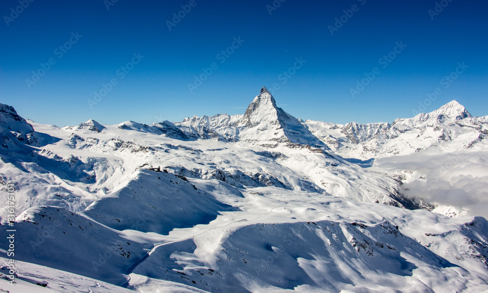 Zermatt Matterhorn and glacier sunset view mountain winter snow landscape Swiss Alps clouds