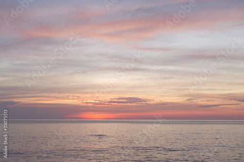 Sea pink sunset. Beautiful color clouds.