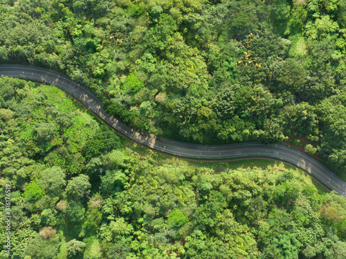 Aerial view of asphalt road in tropical forest.Winding road from the high mountain pass.Top view forest texture landscape