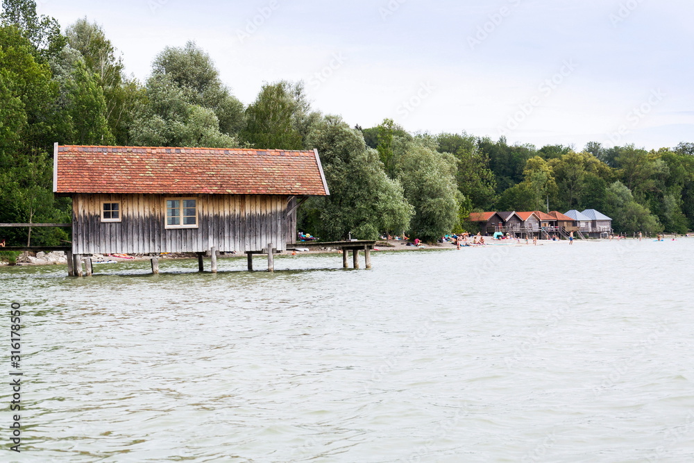 Wooden cottage on pier on the lake Ammersee in Inning am Ammersee, Germany
