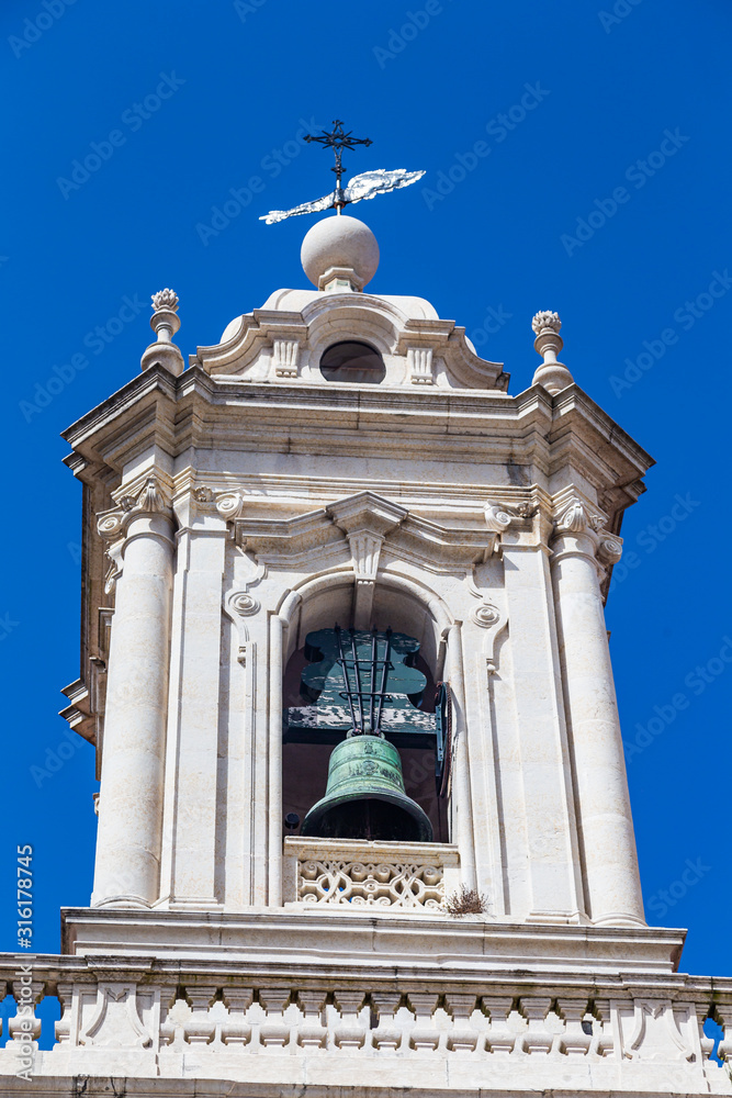 Old bell tower of a Portuguese white church in Lisbon, Portugal