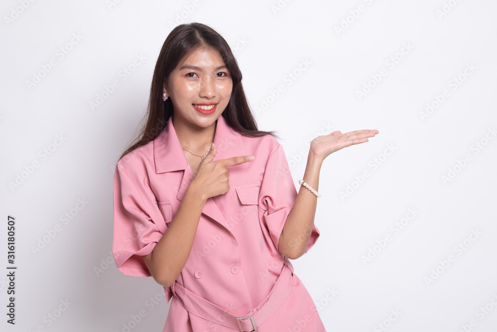 Beautiful young Asian woman point to palm hand. Beautiful young Asian woman point to palm hand.