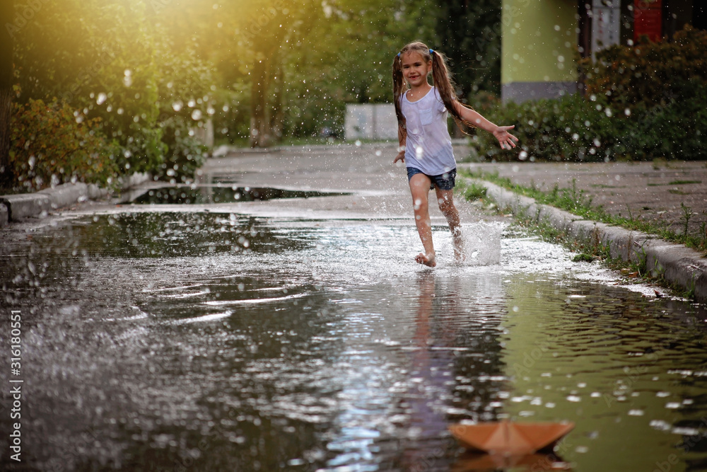 Cute happy kids jumping in the puddles Stock Photo | Adobe Stock