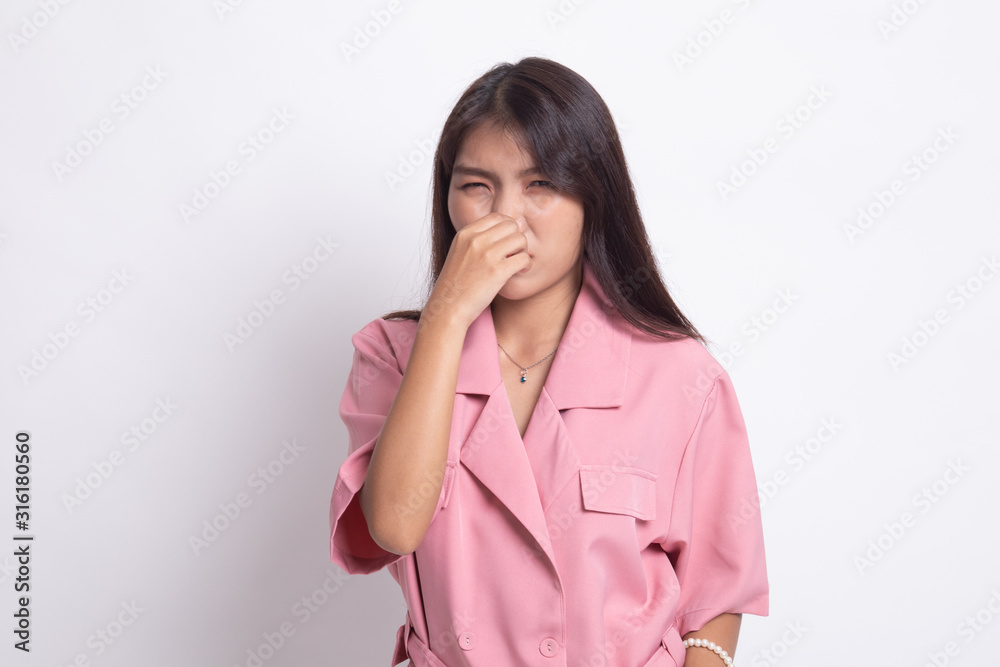 Young Asian woman holding her nose because of a bad smell. Young Asian woman holding her nose because of a bad smell.