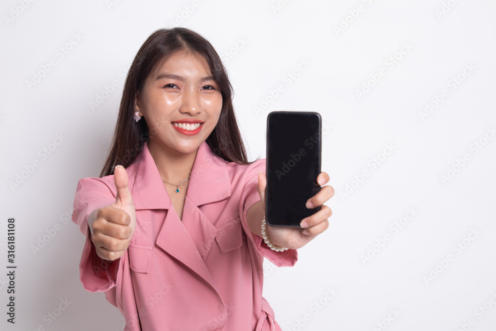 Young Asian woman show thumb up with mobile phone. Young Asian woman show thumb up with mobile phone.