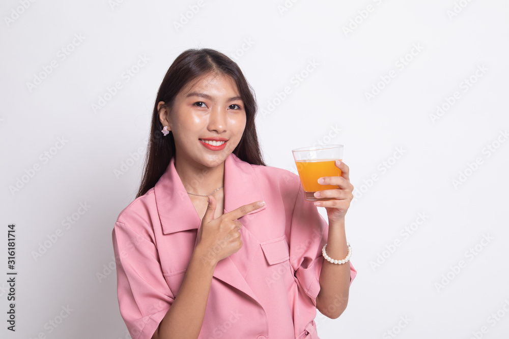 Young Asian woman point to orange juice. Young Asian woman point to orange juice.