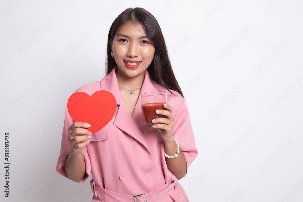 Young Asian woman with tomato juice and red heart. Young Asian woman with tomato juice and red heart.